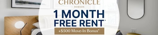 A bedroom with a bed, nightstand, and lamp, advertising a 1 month free rent offer.
