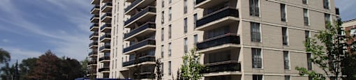 A large apartment building with a blue sky in the background.