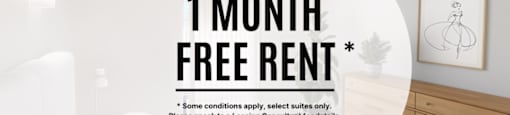 A bedroom with a bed, nightstand, and a framed picture on the wall, advertising a 1 month free rent offer.