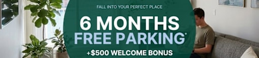 A man is sitting on a couch in a living room with a large green circular sign offering 6 months free parking and a $500 welcome bonus.
