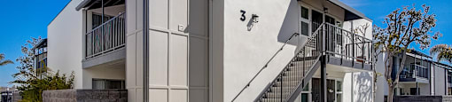 a building with stairs and a blue sky in the background