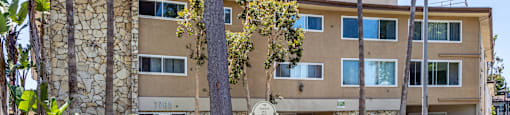 a large apartment building with a sign in front of it