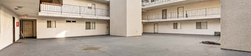 A large open courtyard with a building in the background.