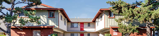 a street view of an apartment building with a driveway