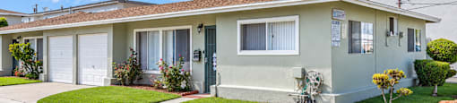 A house with a white garage door and a brown roof.
