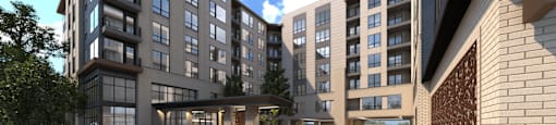 A woman in a beige dress walks in front of a modern apartment complex.