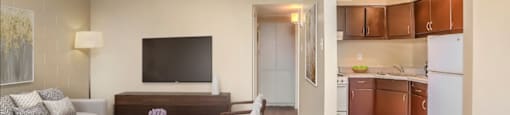 a living room and kitchen with a couch and a table