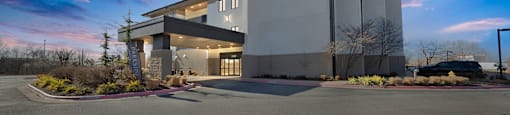 Upscale studio, one, and two-bedroom apartment homes featuring two-tone kitchen cabinetry, quartz countertops, stainless steel appliances, luxury vinyl wood flooring, and much more at Parkside Apartments and Shops in Bentonville, AR