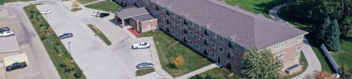 A large building with a parking lot in front of it.