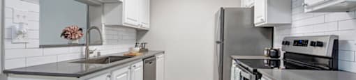 a kitchen with a stove top oven next to a refrigerator