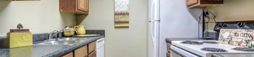 Kitchen with hardwood like flooring and white appliances