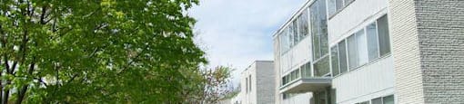 Charlton Apartments exterior with sidewalk and trees