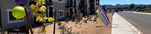 a row of new apartment buildings on the side of a street
