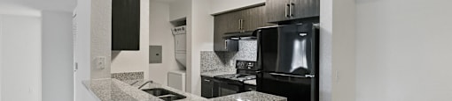 Kitchen counter and appliances at Brenton at Abbey Park Apartments in West Palm Beach FL