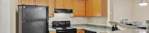 Kitchen with black appliances at Longwood Vista Apartment Homes in Atlanta GA