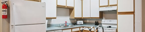 Kitchen with white cabinets at Almeda Park Apartments in Houston TX