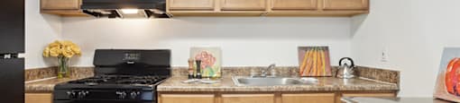 Kitchen with cupboards and appliances at Villages at Marley Station in Glen Burnie MD
