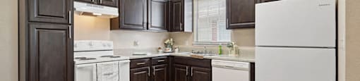 Kitchen with black appliances at Fountains at Tidwell and The Enclave in Houston TX