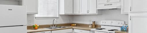 Kitchen with white appliances at Tidwell Estates in Houston TX