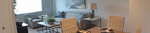 a dining room with a table and chairs and living room in the background  at Valley York Apartments, Ohio