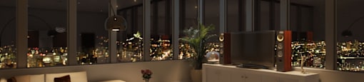 A modern living room with a view of the city at night.