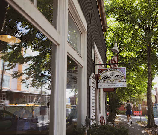 a street view of a restaurant with a sign on the side of a building at Liza Apartments, Washington