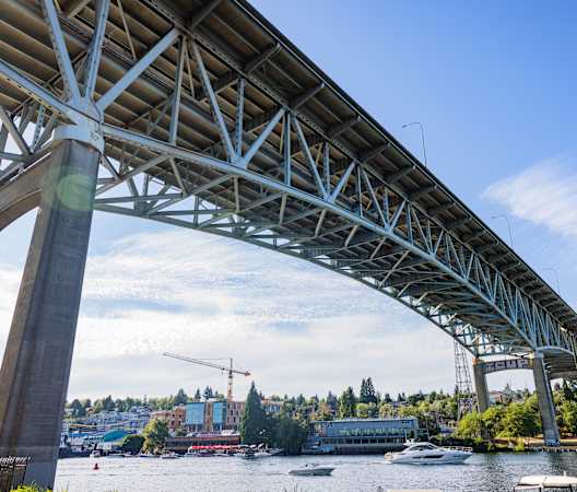 a bridge over the water with boats under it at Liza Apartments, Washington