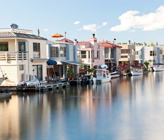 a row of boats docked in the water in a marina at Liza Apartments, Washington