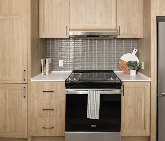a kitchen with a stove and a refrigerator at Liza Apartments, Washington