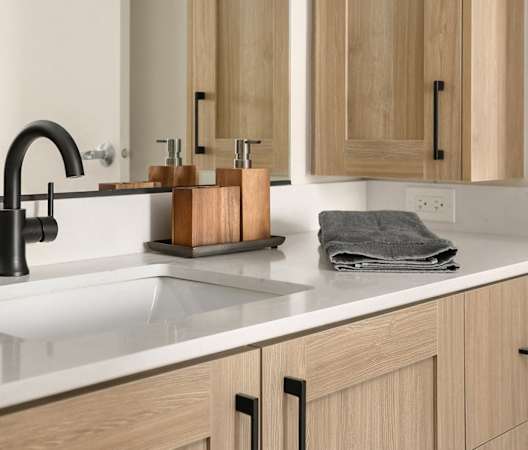 a kitchen counter with a sink and a black faucet at Liza Apartments, Washington