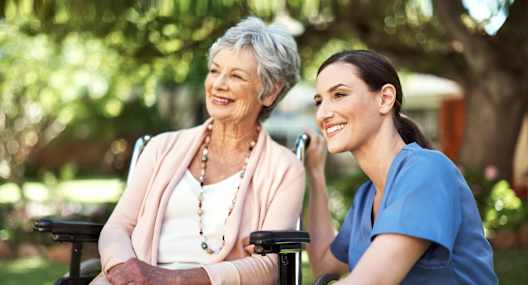 a woman sitting in a wheelchair next to an older woman at Arbor Oaks at Tyrone, Florida, 33710