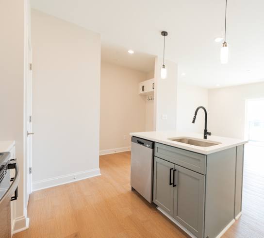 a renovated kitchen with a large island in the middle