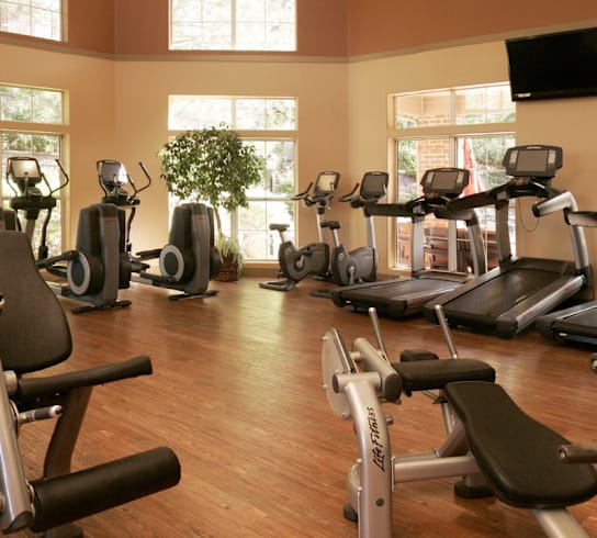 a gym full of exercise equipment in a home gym