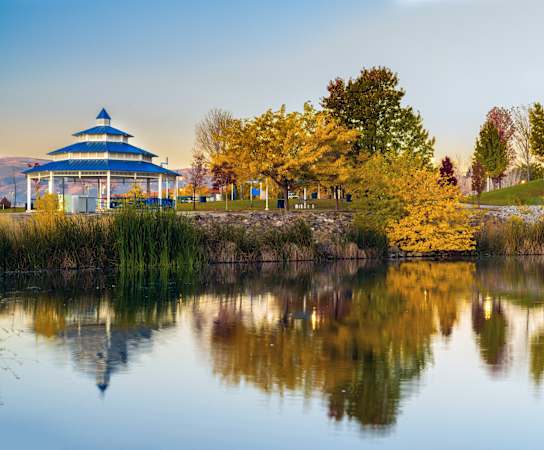 a park with trees and a blue pavilion on the water at Lumina at Spanish Springs, Sparks, 89436