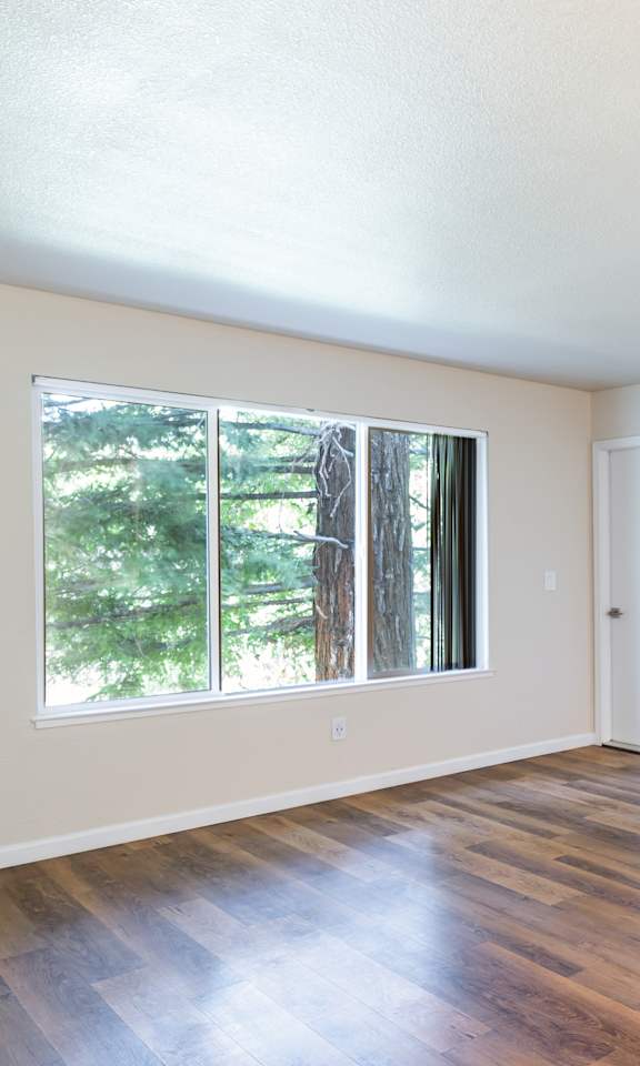 A room with wooden floors and white walls.