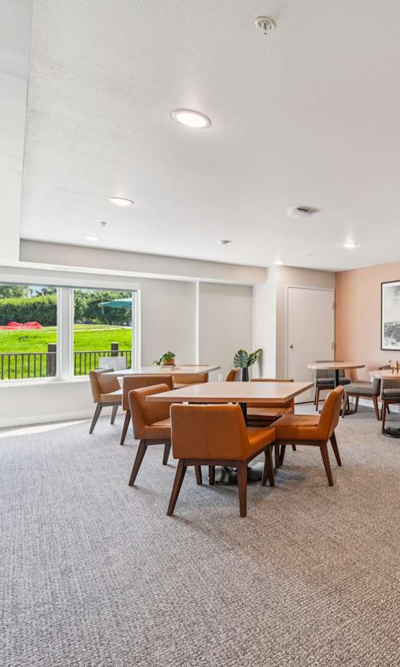 A room with a long table and chairs.