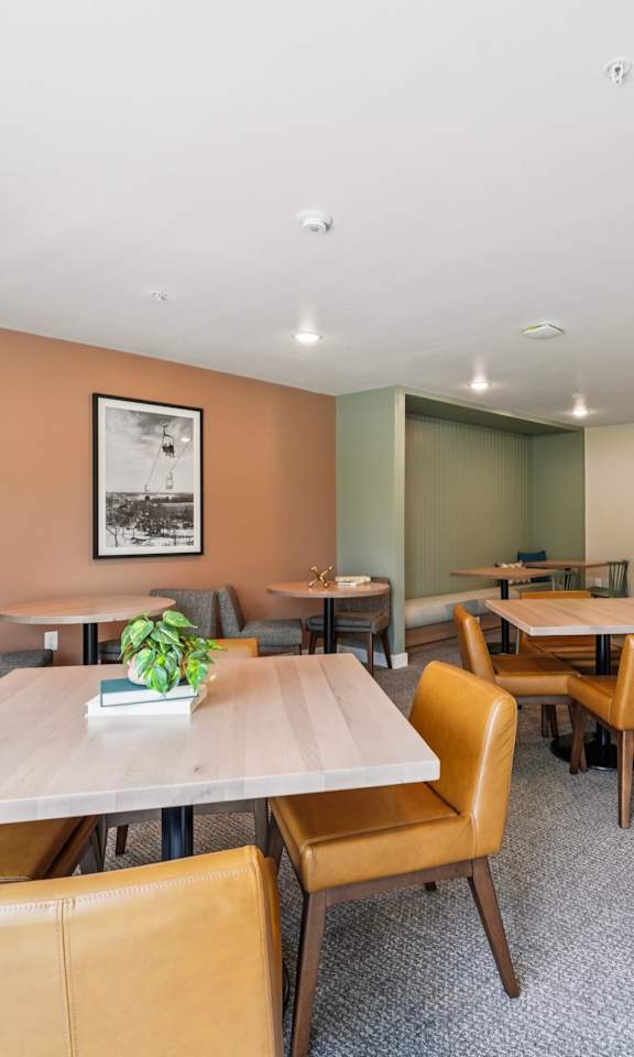 A conference room with a long table surrounded by chairs.
