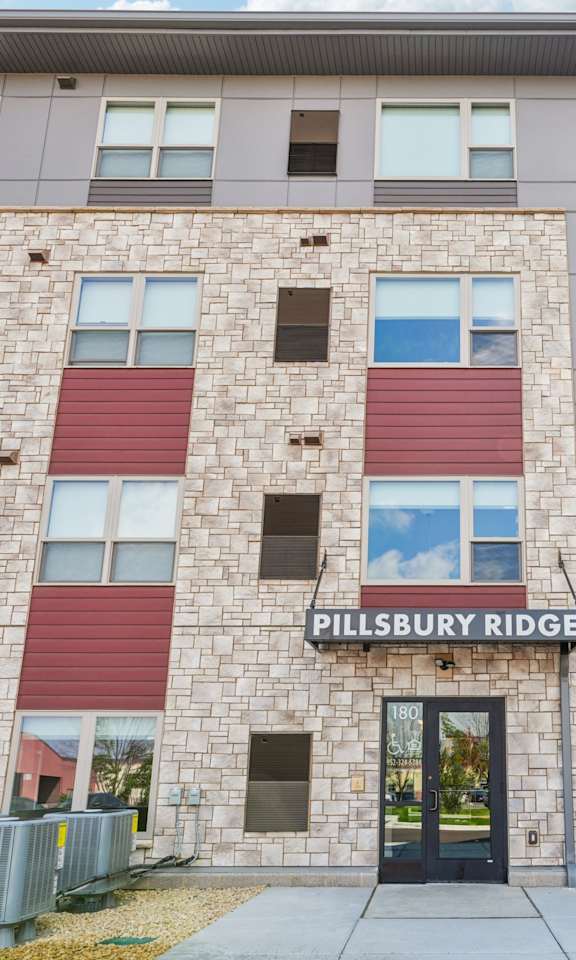 The Pillsbury Ridge building has a grey and red facade.