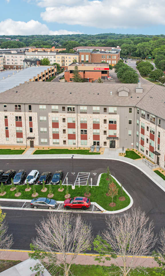A large building with a parking lot in front of it.