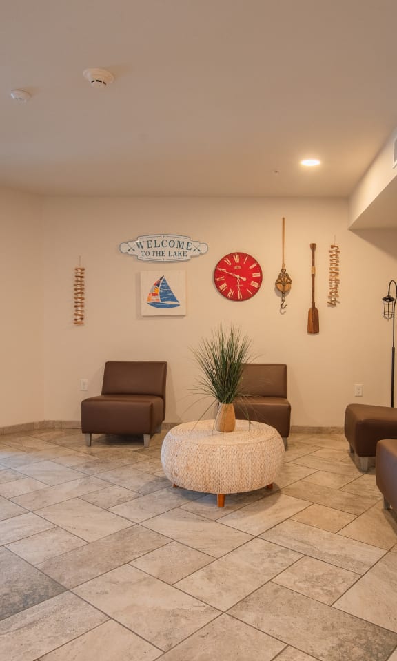 a lobby with couches and chairs and a glass door