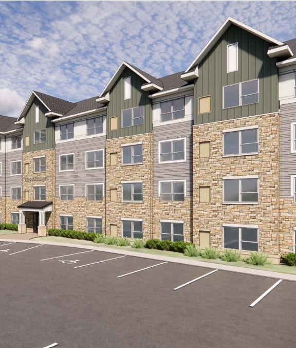 A large building with a parking lot in front.