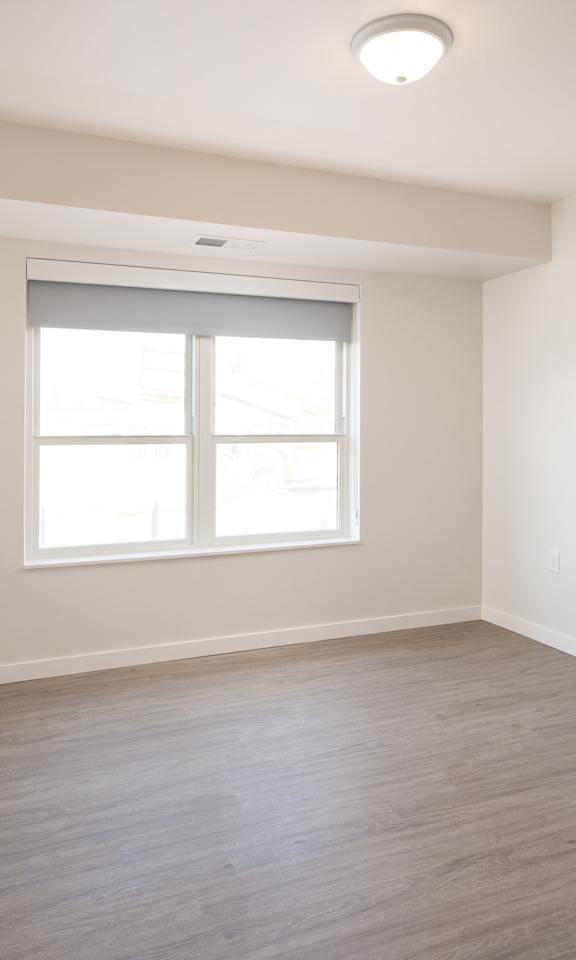 A room with a window and a door handle.
