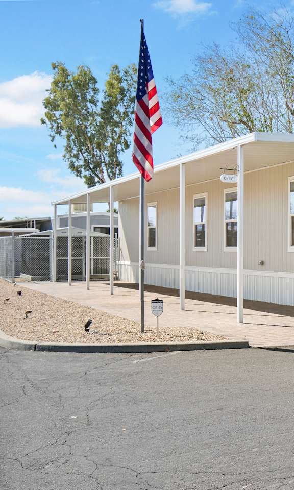 A building with a flag on a pole in front of it.