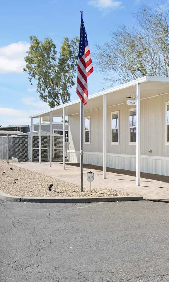 A building with a flag on a pole in front of it.
