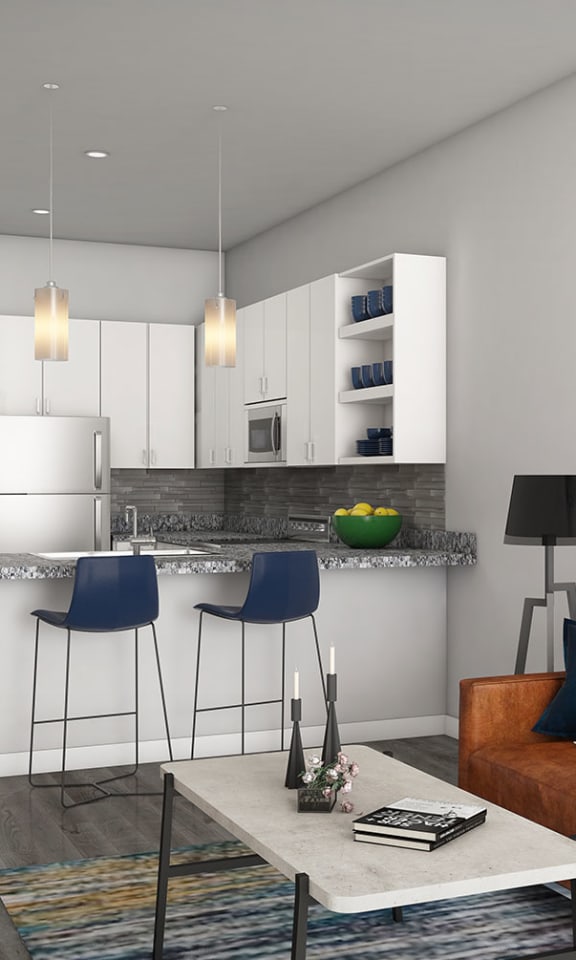 a living room with a couch and a kitchen  at Link Apartments® Canvas, Atlanta