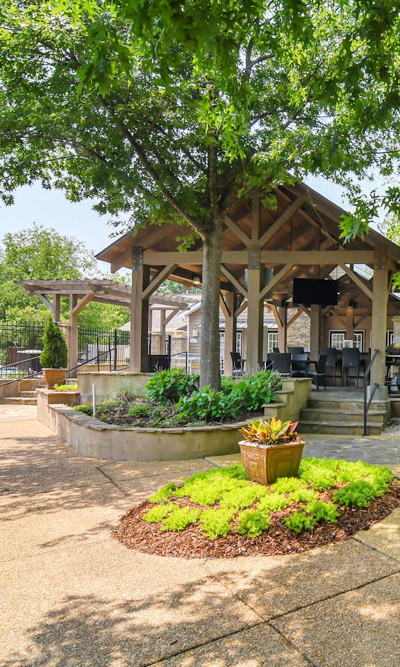 a pavilion in the middle of a park with trees