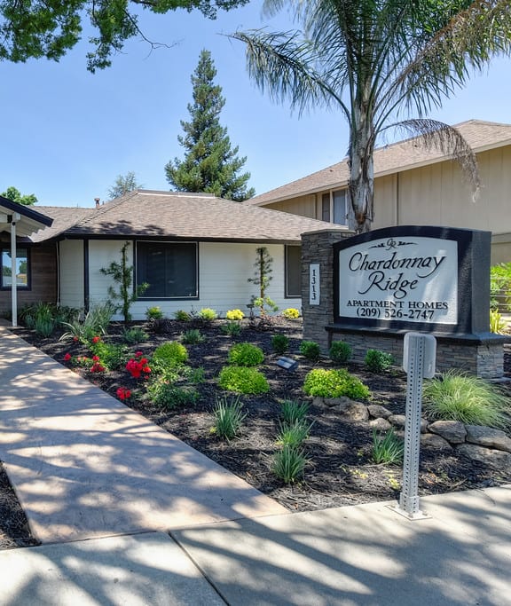 Chardonnay Ridge exterior of leasing office showing monument sign and pathway to leasing office door.