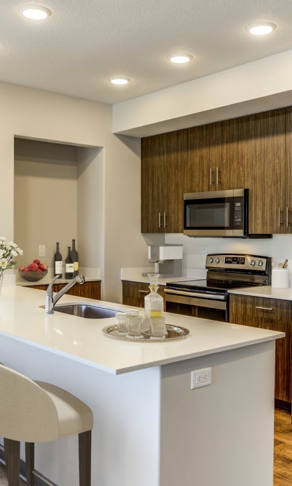 Fairway Flats Apartments Kitchen with Modern Cabinetry, Eat-in Island, and Stainless Appliances