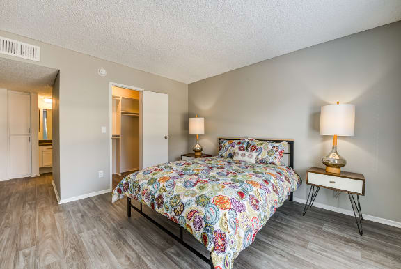 a bedroom with a bed and a mirrored closet