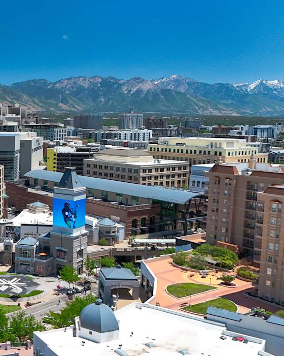 Aerial view of downtown urban skyline with mountains at Liberty Gateway Apartments, Salt Lake City, Utah